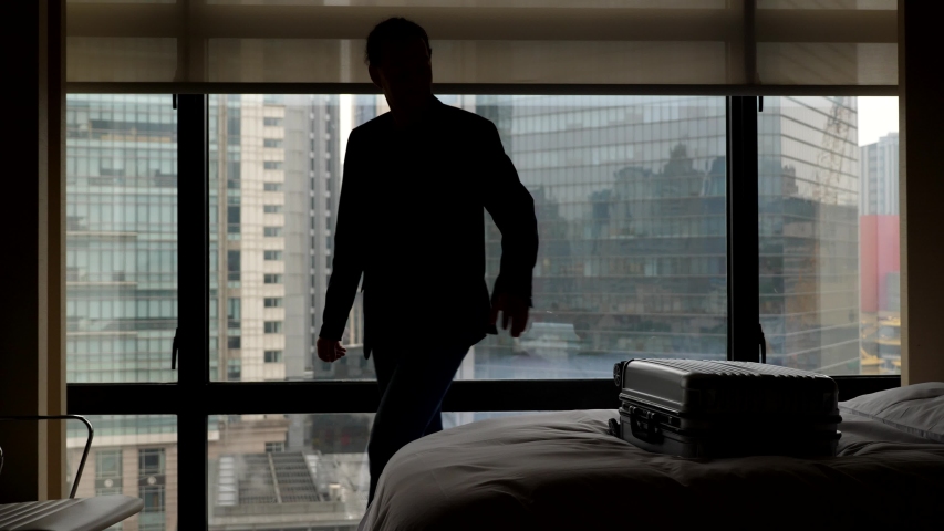 Business man check out from hotel room. Traveller take suitcase from bed and go away, super slow motion shot. Window curtain slowly move down. Royalty-Free Stock Footage #1037403659
