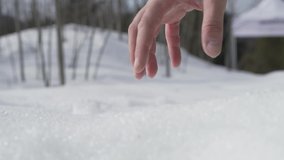 Unrecognizable man holding snow in his hand in the nature stock video