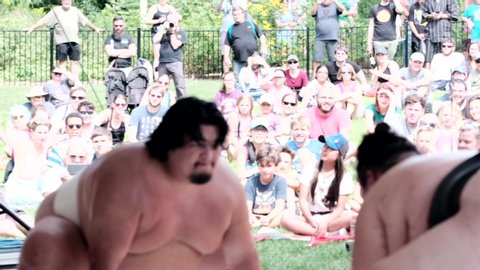 Saint Louis , MO / United States - 08 31 2019: Close up shot of two sumo wrestlers fighting. Slomo.