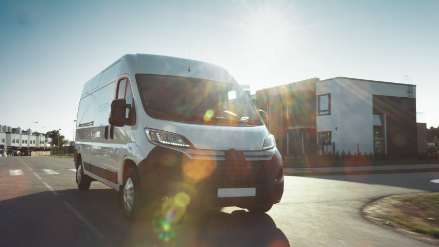 New Delivery Van / Truck Driving Through the Beautiful Suburban Town Area. Postal Delivery Service. Front View Following Shot Royalty-Free Stock Footage #1037416157