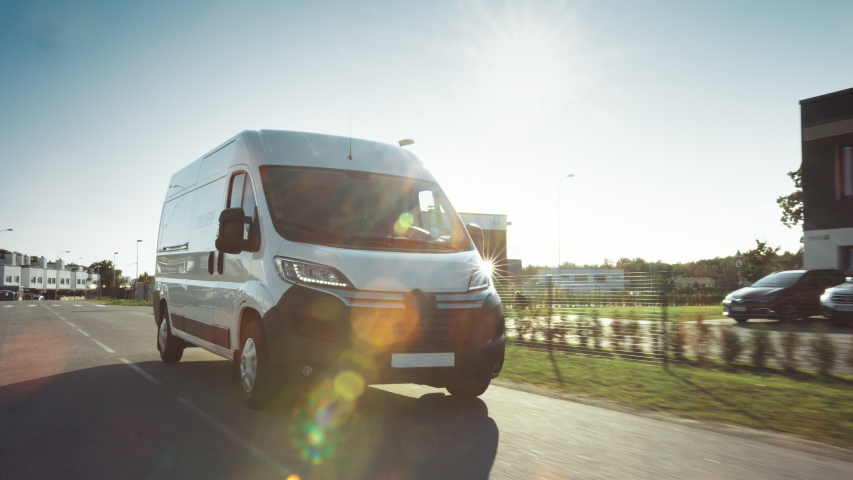 New Delivery Van / Truck Driving Through the Beautiful Suburban Town Area. Postal Delivery Service. Front View Following Shot Royalty-Free Stock Footage #1037416157