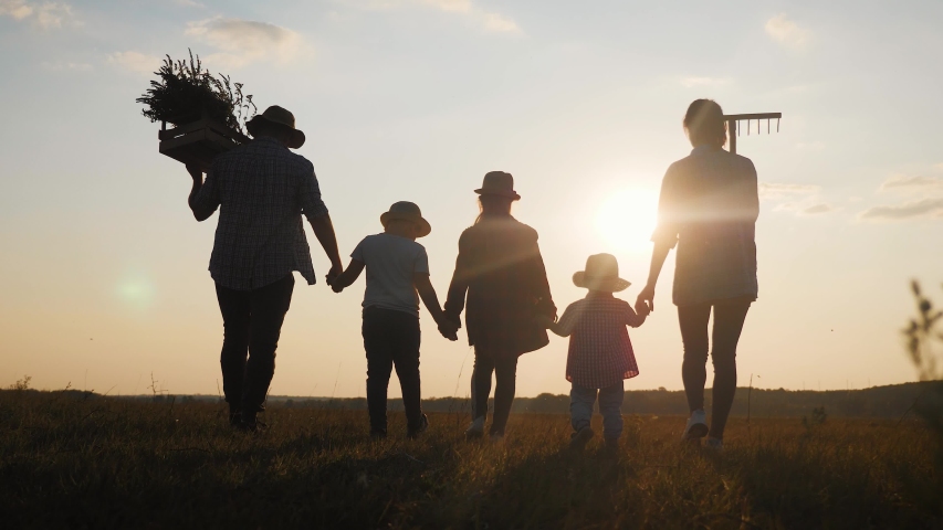 Silhouette farmers family of organic farming and healthy lifestyle, healthy food, happiness and joy. Team work in agricultural harvest farming. Concept of happy friendly family. | Shutterstock HD Video #1037422724