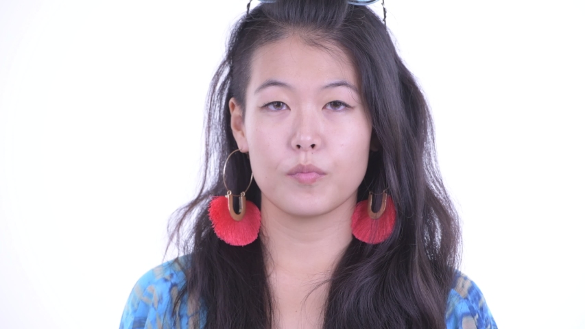 Face of happy beautiful Asian tourist woman smiling and ready for vacation