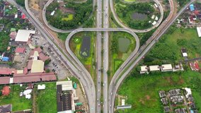 Aerial view 4k video highway ring road bo leaf shape interchange with busy urban traffic speeding on the road Junction network of transportation in Bangkok, Thailand 