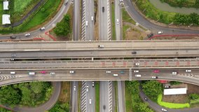 Aerial view 4k video highway expressway and interchange with busy urban traffic speeding on the road Junction network of transportation in Bangkok, Thailand 