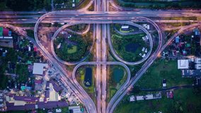 day to night time lapse of aerial view of highway junctions with roundabout. bridge ring roads shape bo leaf in structure of architecture and transportation top view Bangkok Thailand.