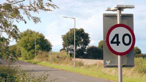 UK Road Sign - 40 Miles Per Hour Sign with Car Driving Past