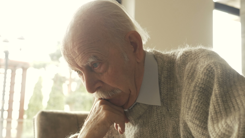 Pensive elder senior man looking away feel upset, thoughtful melancholic older retired gray haired grandpa suffer from sorrow grief loneliness, sad grandfather widower alone at home, close up view Royalty-Free Stock Footage #1037442689