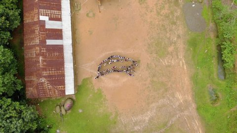 Tamei , Manipur / India - 07 23 2019: Birds eye Top down shot of Students spreading out from the Teachers