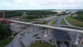 Highway junction bridge flyover infrastructure construction site, aerial pan
