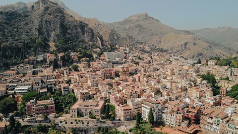 Taormina, SICILY, Italy - August 2019: Ancient city on the plain in the mountains. Aerial drone shot.
