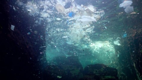 Plastic pollution of the ocean, plastic bags, bottles, bags float in water with jellyfish. Bulgaria, Black Sea
