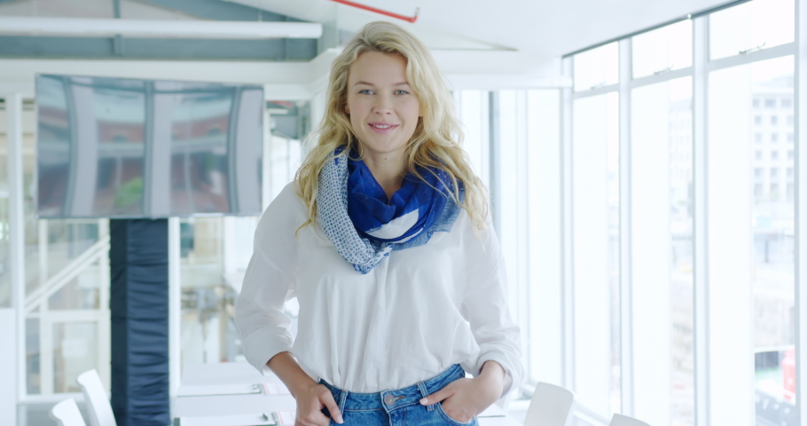 Potrait close up of a young female creative professional smiling to camera in a modern open plan office Social distancing | Shutterstock HD Video #1037455115