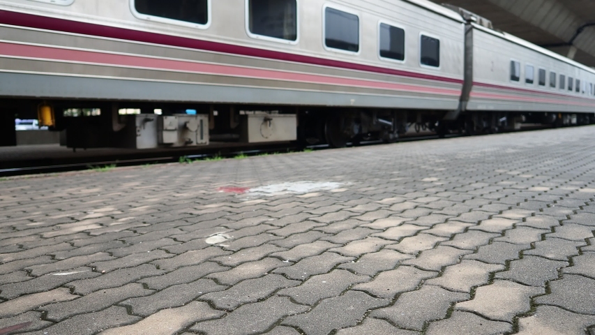 Railroad tracks at train station and sidewalks beside the railway, Transportation and holiday concept.