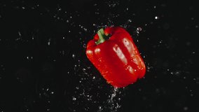TOP VIEW: Red Bell Pepper falls in a water, splashing - Slow motion - Powered by Shutterstock - Get 15% off with code: PIKWIZARD15