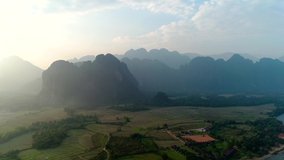 4k Video shot aerial view by drone. River at the village of Vang Vieng on Laos. Sunset landscape