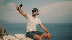 Selfie On Mobile Phone In Beautiful Place In Turkey Trip. Man Taking Self Photo And Answer To Video Call Sea Cliff. Guy Takes Pictures On Smartphone On Seashore. Man Taking Selfie On Holiday Vacation