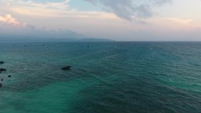 Tropical beach with sailing yachts, aerial view during sunset, Boracay, Philippines, clear sea water, 4K video, azure water