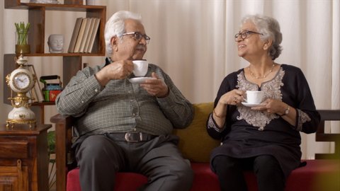Beautiful old Indian couple having a good time over a cup of tea. Indian stock footage of a beautiful old Indian couple having a good time and chatting over a cup of tea