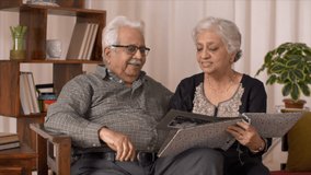 Clip of a romantic moment between an elderly Indian couple. HD video clip of an elderly Indian couple having a romantic moment while going through their wedding album