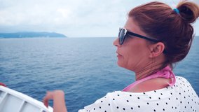 Video of a woman sailing a ship on the sea and showing the way.