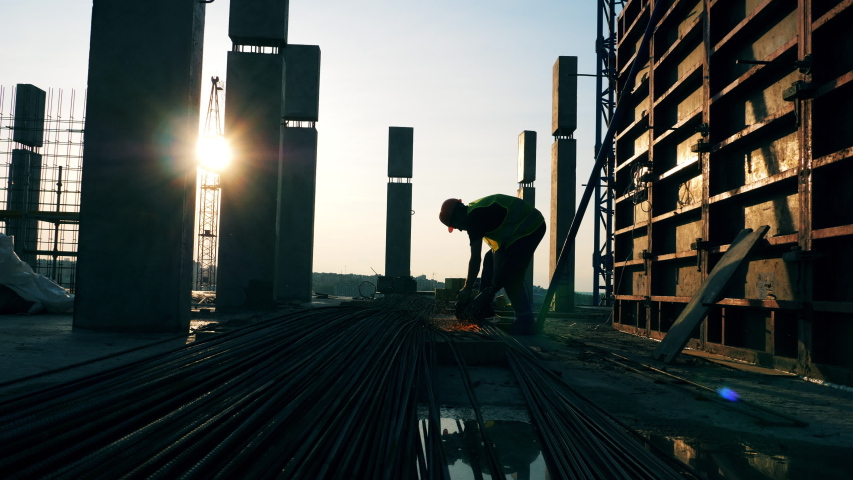A worker uses disk saw on a construction site. Royalty-Free Stock Footage #1037519213