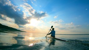 Backside view of a man sailing on a canoe - Powered by Shutterstock - Get 15% off with code: PIKWIZARD15