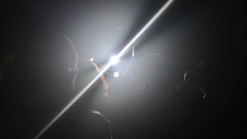 Stage Spotlight with Led light girl at a concert seating on shoulders ...