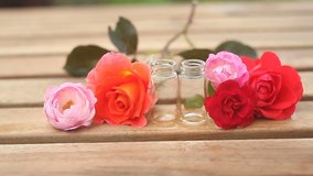 Essence of rose on table in beautiful glass bottle