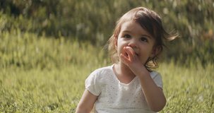 Cute baby girl exploring a park in late summer. Shot in 4K RAW on a cinema camera. 