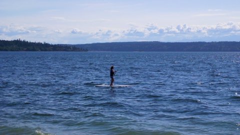 Camano Island State Park, Washington State. Nondescript, stand-up paddle boarder in the distance. 5 sec/24 fps. Version 1