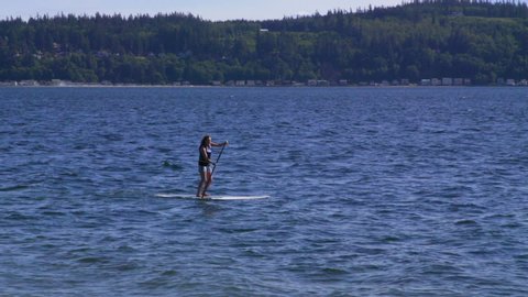 Camano Island , WA / United States - 05 19 2019: Standup Paddle Boarder in Elger Bay