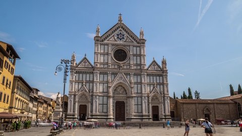 Timelapse footage of Tourists on Piazza di Santa Croce with Basilica di Santa Croce Basilica of the Holy Cross in Florence city before sunset. The church is burial place of famous Italians.