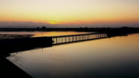 Sunrise view over the Dublin coastline and Bull Island bridge.  Cinematic Irish landscape at golden hour.