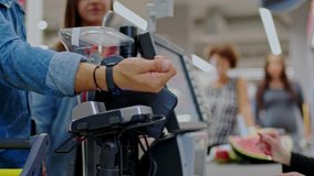 Man paying with a smart watches in a grocery store - Powered by Shutterstock - Get 15% off with code: PIKWIZARD15