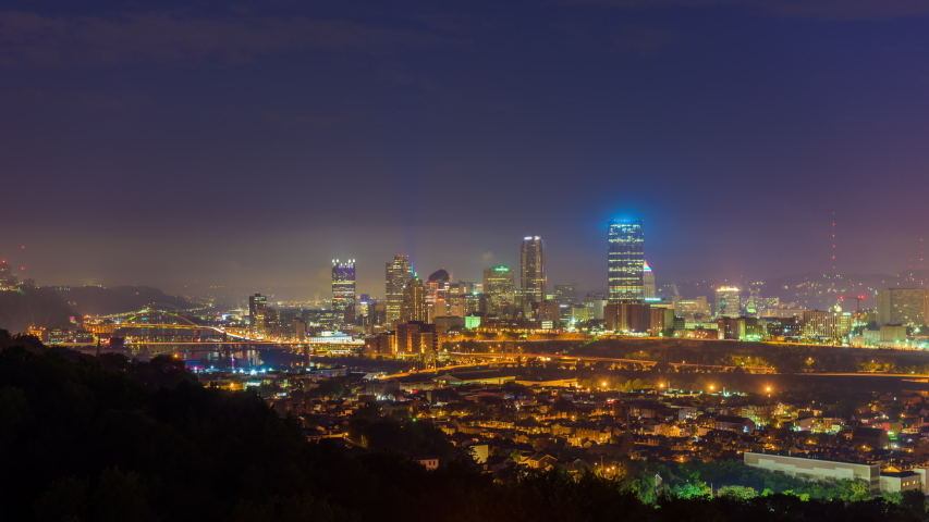 Pittsburgh, Pennsylvania, USA downtown skyline from the south side from night to morning.