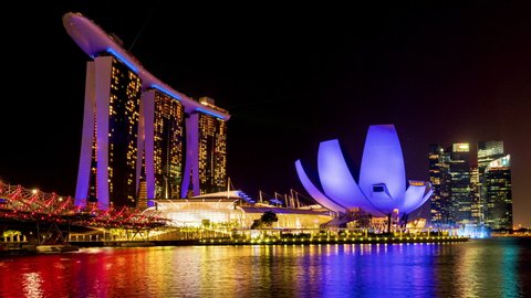 Time lapse video of the Singapore at night time. Views of Marina Bay at night with colorful light from hotels and buildings around Marina Bay