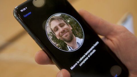 BARCELONA SPAIN 20 SEPTEMBER 2019: Man face id facial recognition ios 13 presentation of the iPhone 11 pro and sales of new Apple products in the official Apple store in. 