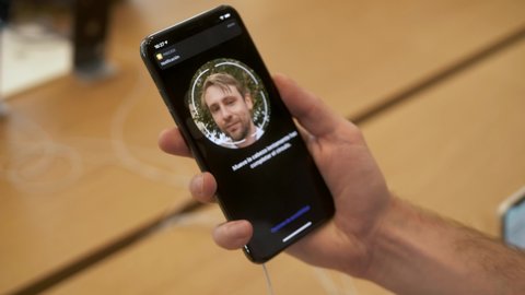BARCELONA SPAIN 20 SEPTEMBER 2019: Man face id facial recognition ios 13 presentation of the iPhone 11 pro and sales of new Apple products in the official Apple store in. 