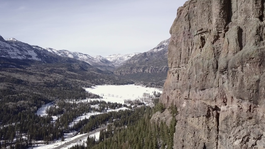 Drone mountain reveal from behind rock cliff near Pagosa Springs, CO