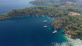Mediterranean Sea, coast of Turkey. Islands yacht parking in a picturesque bay. Aerial video shooting.