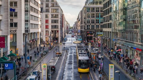 Berlin, Germany - September 22, 2019: Time lapse view of pedestrians, trams and traffic on famous Friedrichstrasse street in Central Berlin by day during fall season. 