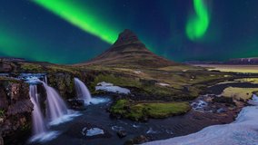 Time lapse of Northern Lights (Aurora borealis) at Kirkjufell mountains and kirkjufellsfoss in Iceland.