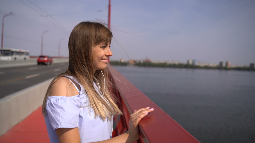 A young girl walks on a new bridge over the Dnieper River