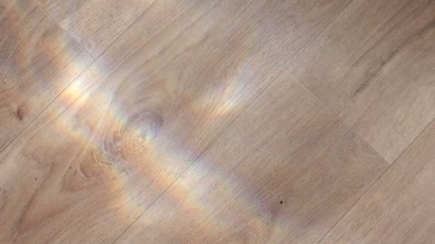 Sunlight from the water on the wooden floor. Close-up sunlight shimmers on the floor with a wooden surface.