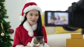 Beautiful asian woman blogger showing her cat in front of camera to recording vlog video live streaming .Business online influencer on social media concept. 