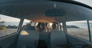 Slow motion of group of young multi-ethnic friends just arrived with a minivan are happy to start their vacation  and having fun on a beach with a sea on a sunset.
