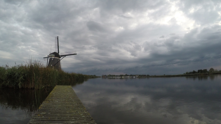 Time lapse of an arcus cloud of a thunderstorm over windmill near lake Rottemeren in The Netherlands