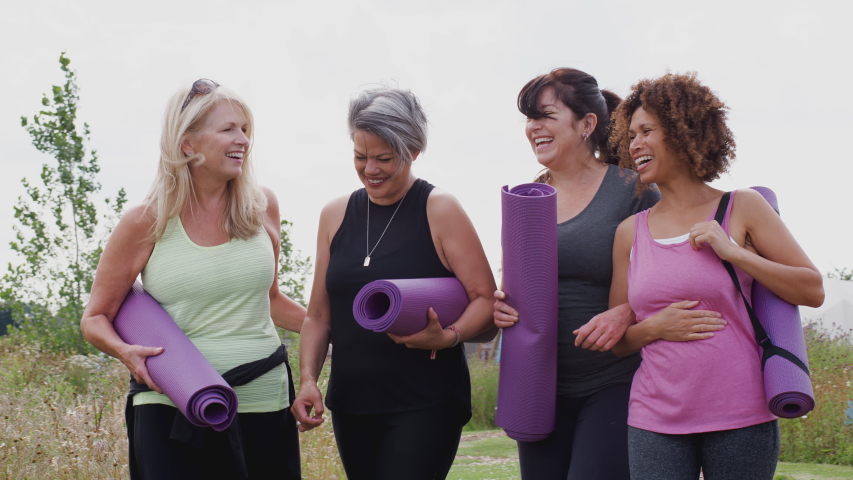 Group Of Mature Female Friends On Outdoor Yoga Retreat Walking Along Path Through Campsite | Shutterstock HD Video #1037640230
