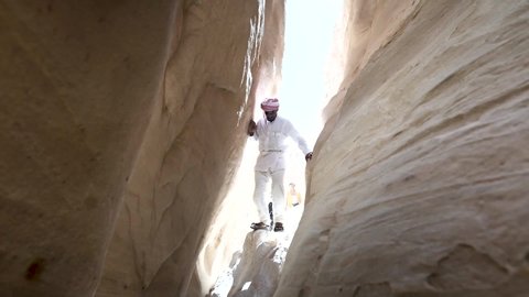 Dahab / Egypt - 03 24 2019: Arabic Guide exploring coloured canyon in dahab